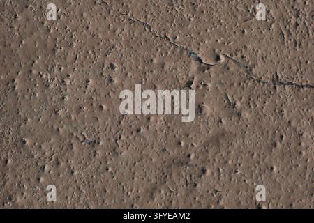 Detailed and colorful close up at cracked and peeling paint on concrete wall textures in high resolution Stock Photo