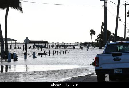 The Halifax River floods a street as well as boat docks, the result of ...