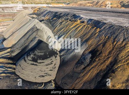 Aerial view of Garzweiler surface mine showing large piles of excavated coal and earth in the open-pit mining site in Juchen, North Rhine-Westphalia, Stock Photo