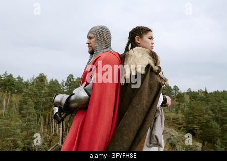 Middle Aged Knight and Latin Woman Standing in Nature Stock Photo