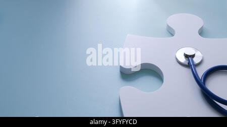 Stethoscope placed over a white human-figure puzzle piece on a clean light blue background with copy space, ideal for medical research, healthcare ban Stock Photo