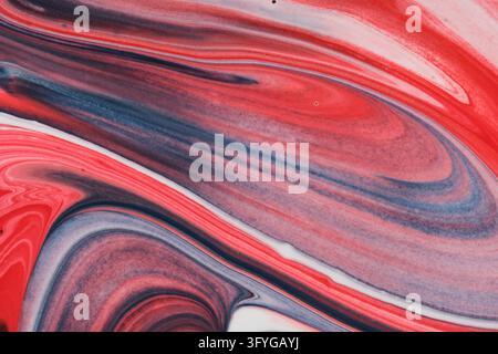 Elegant abstract background with swirling red, white, and navy blue liquid acrylic paint layers Stock Photo