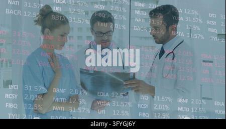 Three medics reviewing clinic tablet while woman touching neck and man gesturing near ticker data. Healthcare, doctors, teamwork, consultation, diagno Stock Photo