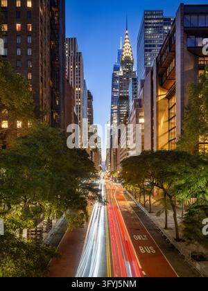 New York City, Midtown Manhattan, street view along 42nd Street at twilight, with illuminated skyscrapers and traffic light trails Stock Photo