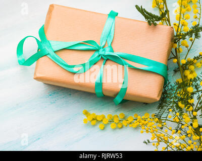 Mimosa and gift box with green ribbon. Woman's day symbol ...