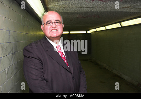 Menacing businessman in suit confronts you in subway. Stock Photo