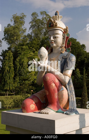 Statue of bodhisattva holding a conch shell at Kagyu monastery in Sarnath, near Varanasi, Uttar Pradesh, India. Stock Photo
