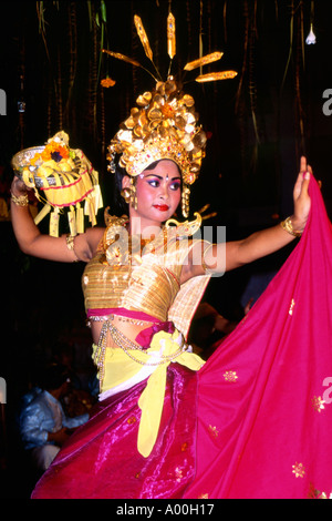 pretty female dancer in traditional dress performing a traditional dance at a temple opening ceremony near ubud bali indonesia Stock Photo