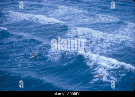 helicopter view of surfers on waves on North Shore of Oahu Hawaii Stock Photo