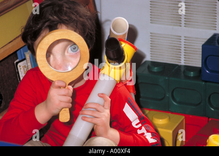 Pre school boy looking through a magnifying glass St Paul Minnesota Stock Photo