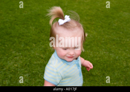 Fourteen Month Old Girl on Grass in Park Stock Photo