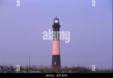 Lighthouse in blue sky with sunset reflections on Fire Island, Long Island New York State USA Stock Photo