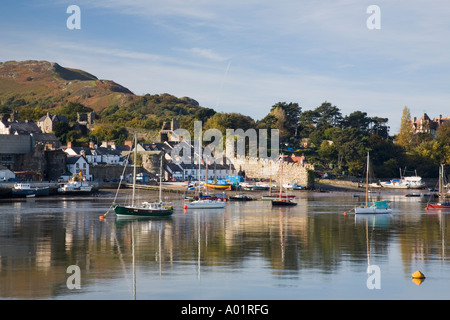 View across Afon Conwy river estuary to town walls and quay across harbour with moored boats. Conwy, Conwy county, North Wales, UK Stock Photo