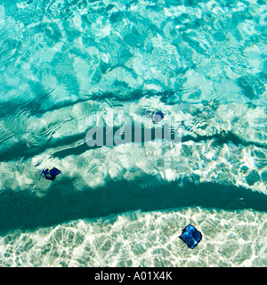 Blue water at the edge of a swimming pool Stock Photo
