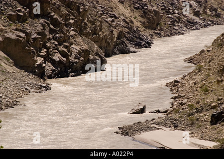 Indus river near Dha Hanu village, site of the Dard or Brokpa tribe in the Indus Valley, Ladakh, India. Muddy water flows through a rocky canyon. Stock Photo