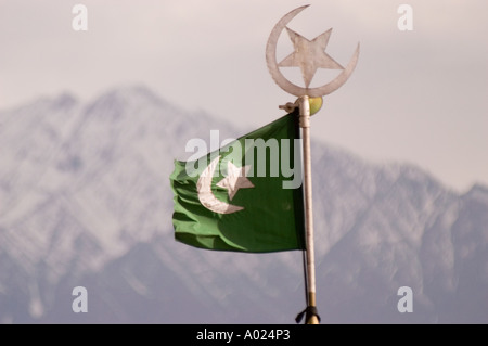 Muslim star and moon on flag top of Jama Masjid mosque with snow capped mountains in background Leh Ladakh India Stock Photo
