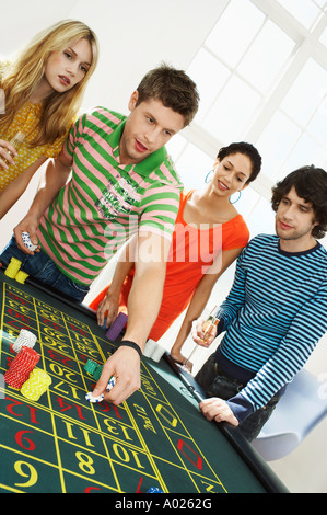 Friends Gambling on roulette table Stock Photo