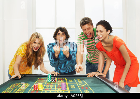 Friends celebrating win on roulette table Stock Photo