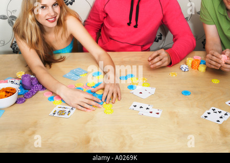 Friends Playing Cards, woman grabbing chips Stock Photo