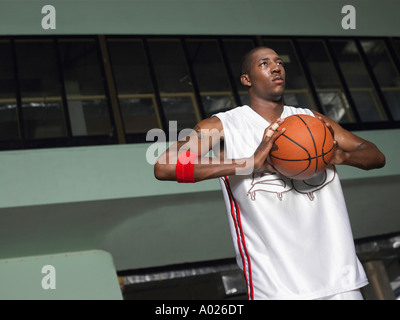 Basketball player preparing to pass ball, portrait Stock Photo