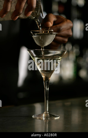 Bartender pouring a drink on a bar Stock Photo