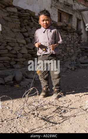 Zanskari boy holding a handmade toy car made from metal wire in Zanskar, Ladakh, Kashmir, India. Stock Photo