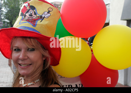 Miami Florida,Coconut Grove,Mad Hatter Arts Festival,festivals,celebration,fair,smiling woman,Mickey Mouse hat,balloons,visitors travel traveling tour Stock Photo