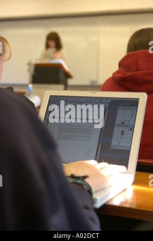 student using a laptop computer to take notes in classroom during a lecture at Aberystwyth University Stock Photo