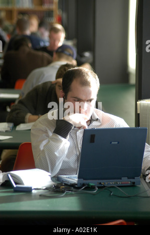 male student in library University of Wales Aberystwyth using laptop personal computer Stock Photo