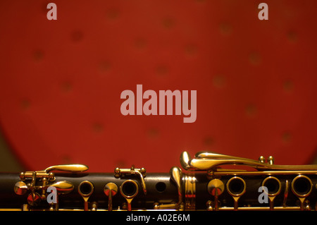 detail of a clarinet resting on a red background Stock Photo