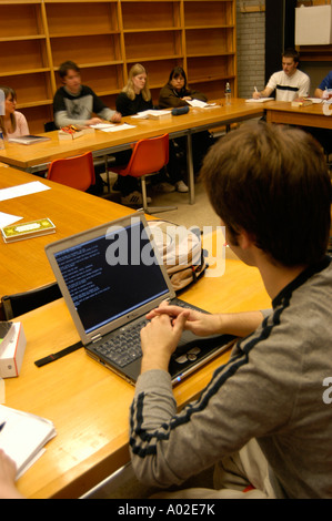 young male Student with laptop computer takijng notes during an english literature seminar Aberystwyth University wales Stock Photo