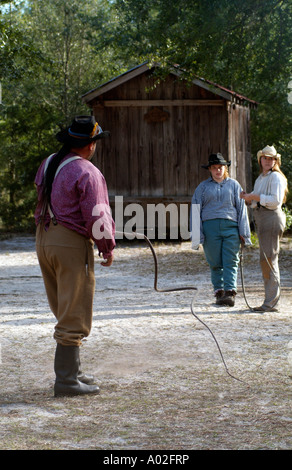 Cowboy cracking a stockwhip Whip cracking demonstration at Silver River State Park in Ocala central Florida America USA Stock Photo