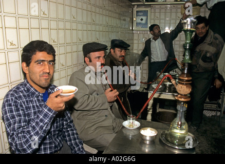Drinking tea and smoking hookah at a tea house in Tehran Iran Stock Photo