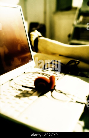 A person relaxing near the laptop computer Stock Photo