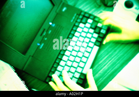 Hands typing on laptop view from above Stock Photo