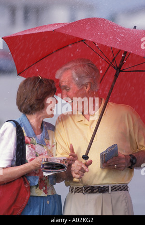 Portrait Caucasian senior couple rain Stock Photo