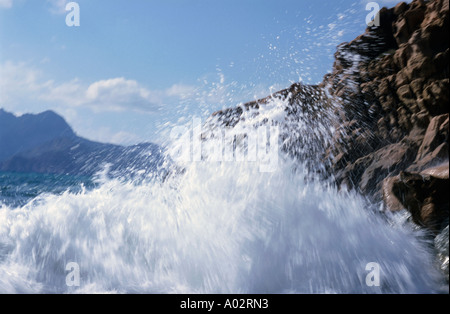 France Corsica Island Porto Beach Waves Crashing Against Red Rocks Stock Photo