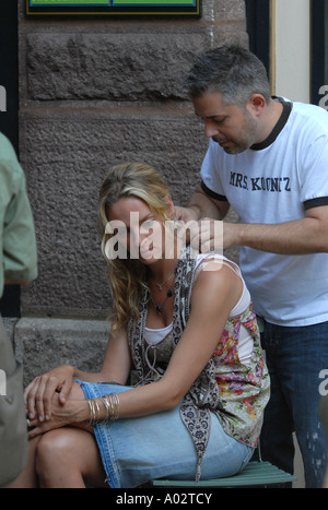 Actress Uma Thurman gets her hair adjusted by a makup artist while working on the movie In Bloom Stock Photo