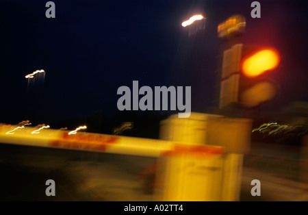 Passing a toll bridge barrier on a highway at dawn Stock Photo