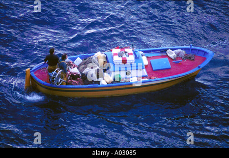 An inshore fishing boat leaving harbour to set its nets in the Mediterranean off the Amalfi coast Stock Photo