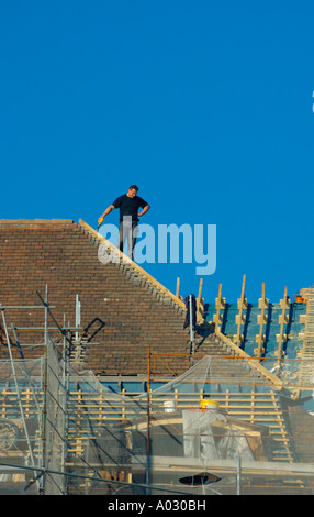 Roofer taking a break to consider his work Stock Photo
