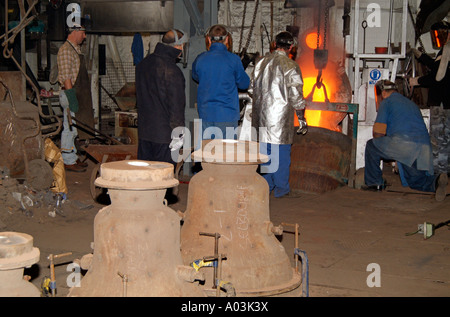 Bell manufacturing. Pouring molten metal from the furnace. Whitechapel Bell Foundry London England UK Stock Photo