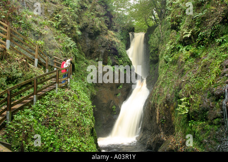 two boys looking at Ess-na-Larach Waterfall in the Glens of Antrim in Northern Ireland Stock Photo