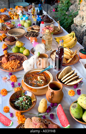 Day of the Dead display of offerings including food drink marigolds and animals made of sugar Stock Photo
