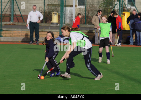 Youth field hockey match mixed gender with both boy and girl team players Stock Photo