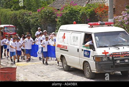 GUATEMALA Panajachel Guatemalan school children run behind a flaming torch bearer Stock Photo