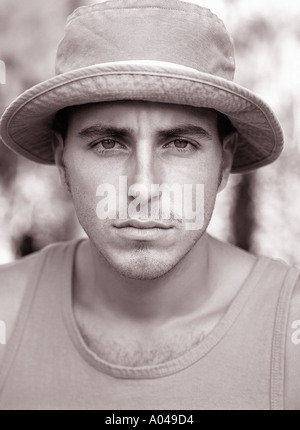 Portrait of a young man facing the camera wearing a sun hat Stock Photo