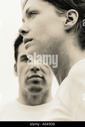 Portrait of a young man and woman looking in opposite directions Stock Photo