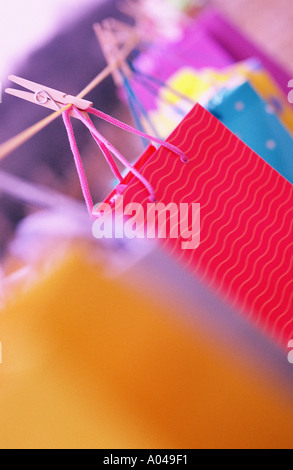 various colourful shopping bags pegged onto a clothes line Stock Photo