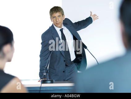 Speaker standing next to microphones during seminar Stock Photo